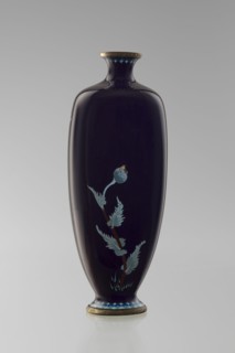 Angular vase one of a pair with rounded edges, on a low round foot and with a short neck slightly