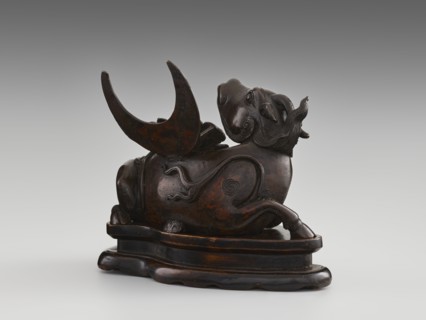 Mirror pedestal — lying unicorn on base; carved wooden base; qilin unicorn iconography; crescent