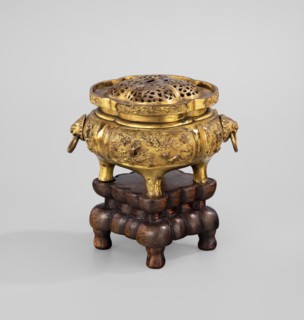 Incense burner with a cover on a base. Incense burner modeled on the ding type with a four-petal