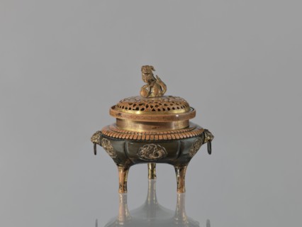 Incense burner koro of the ding type with a cover. Incense burner with two handles knobs, on three