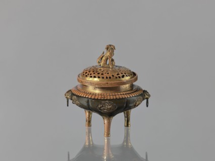 Incense burner koro of the ding type with a cover. Incense burner with two handles knobs, on three