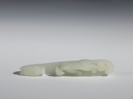 Belt clasp;, Milky-white, slightly translucent jadeite with slight colloid clusters. Carved and