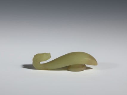 Belt clasp;, Jadeite with visible clusters of colloids in a green hue; pointed handle and slightly