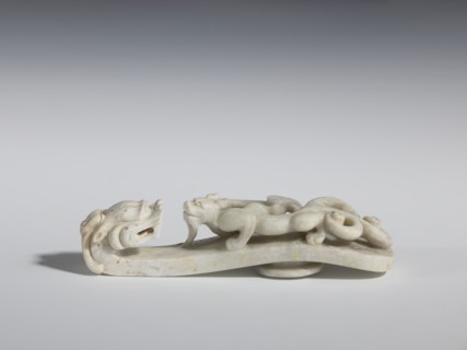 Belt clasp. Handle: stylized lizard-dragon qilong. Milky-white jadeite. Full-plastic carved head,