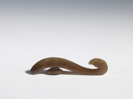 Belt clasp, Chinese, Qing 1644–1911, 18th–19th century. Brown jade with lighter spots; full-plastic