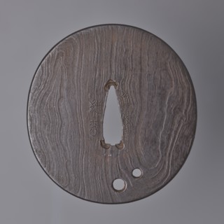 Crossguard tsuba, Tsuguhide. Oval tsuba tatemaru gata with a kaku mimi ko-niku type edge. Flat,