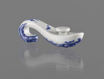 Belt clasp, Chinese; 19th century. Porcelain belt buckle decorated with navy blue overglaze enamel