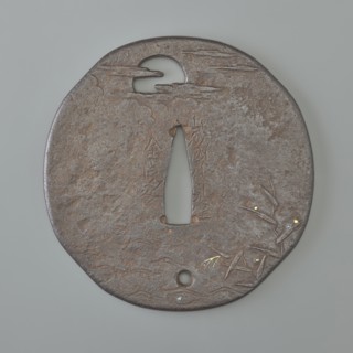 Crossguard tsuba, Kaneie,  school craftsman author. Japanese iron oval tsuba with an irregular