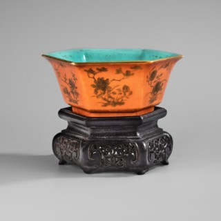 Bowl on a stand. Decoration: peony bushes on an orange background; turquoise bottoms inside and in