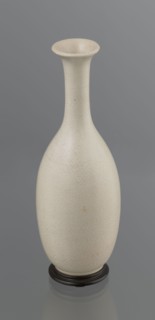 Vase on saucer. Vase made of stoneware or thick porcelain?, ovoid with a long cylindrical neck,