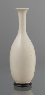 Vase on saucer. Vase made of stoneware or thick porcelain?, ovoid with a long cylindrical neck