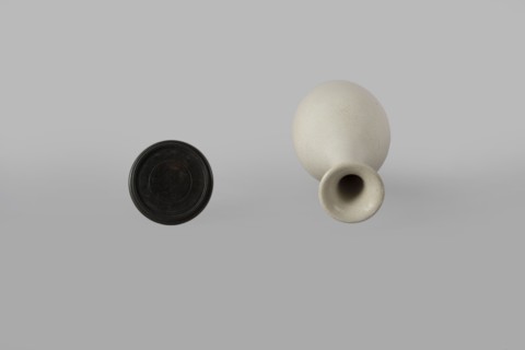 Vase on saucer. Vase made of stoneware or thick porcelain?, ovoid with a long cylindrical neck