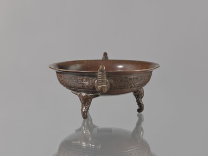 Ding vessel, Tripod bronze vessel with three legs and two handles; used for ritual hand washing.