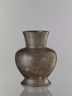 Vase, pewter alloy ovoid bulbous vase on a wide base with a wide flared neck. Engraved decoration