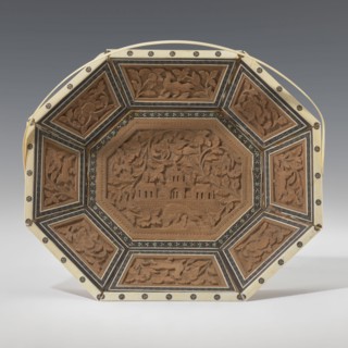 Basket. Octagonal, shallow wooden basket with an ivory rim and handle. Inside the basket is a