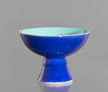 A porcelain footed bowl, Chinese, 19th century Qing Dynasty. Cobalt blue exterior glaze, green