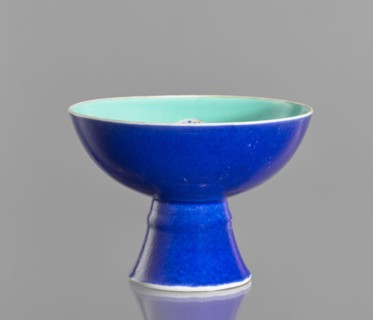 A porcelain footed bowl, Chinese, 19th century Qing Dynasty. Cobalt blue exterior glaze, green
