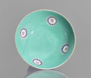 A footed porcelain bowl, Chinese, 19th century Qing Dynasty. Cobalt blue exterior glaze, green