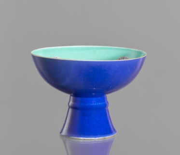 A tall footed porcelain bowl, Chinese, 19th century Qing Dynasty. Outer glaze stained cobalt, inner