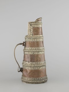 Teapot, maker, 19th century, Tibet. Teapot jug tapering towards the top with silver fittings and a