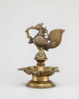 Oil lamp, round base with a pentagonal oil vessel and a bird figurine on top; 19th century South