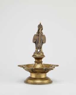 Oil lamp, Round base with a pentagonal vessel for oil topped by a bird figurine rooster/swans/geese