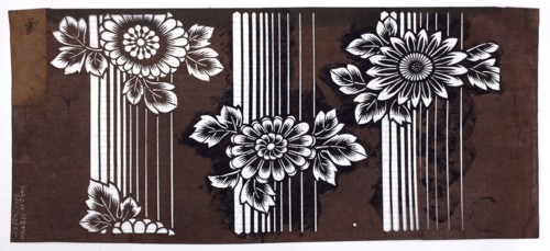 A katagami dyeing stencil cut into a pattern of chrysanthemum flowers against a background of