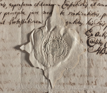 Round seal impression of the town of Chojnice. Ox head with curled horns. Between the horns and on