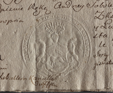 Round seal impression of the town of Kleszczele, Podlaskie Voivodeship. A shield supported by two