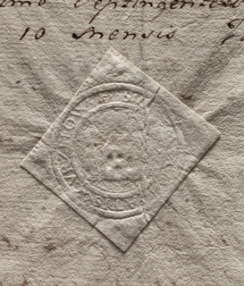 Round seal impression of the town of Kurzelów. Illegible drawing (gate with a tower?). Illegible