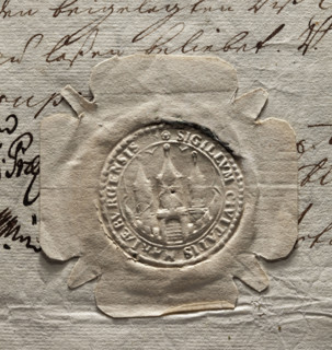 Round dry impression of the seal of the town of Malbork made on a three-page document. In the inner