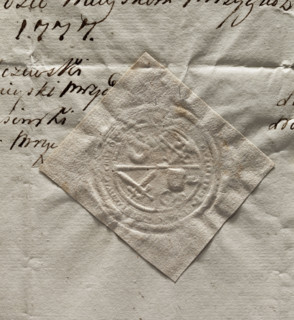 Round seal impression of the town of Mrzyglód. Central quadripartite field with an illegible