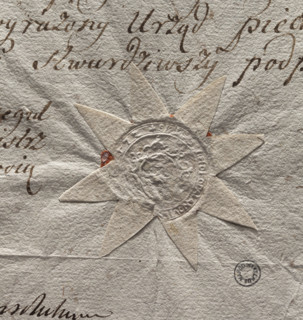 Round seal impression of the town of Odolanów. In an oval decorative cartouche an illegible drawing
