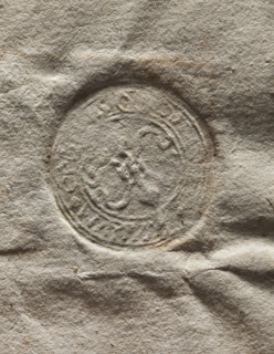 Round seal impression of the town of Ogrodzieniec. Two lilies joined by a ring — the Bonarowa coat
