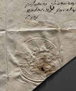 Round seal impression of the city of Olsztyn. On a round, richly decorated, crowned shield, an