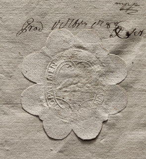Oval seal impression of the town of Opalina. In the decorative crowned cartouche, an illegible