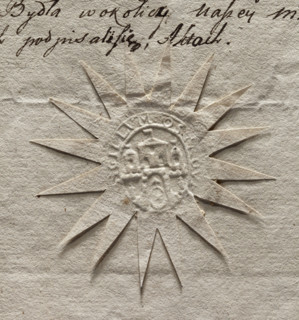 Oval seal impression of the city of Ostrowiec. City walls with three towers with flags on the roofs