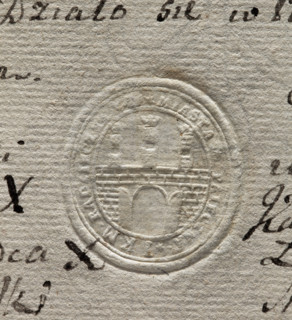 Oval seal impression of the town of Pajeczno. City wall with an open gate and three towers topped