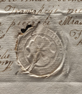 Round seal impression of the town of Pilica. In the decorative cartouche a rooted lily. Illegible