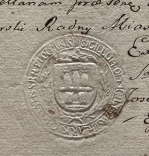 Round imprint of the city seal of Plock. On a vertically hatched shield surrounded by laurel