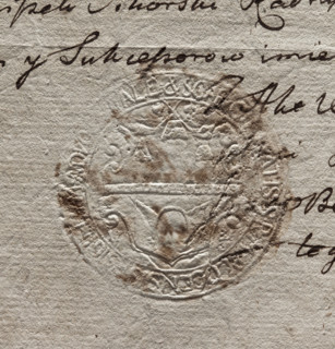 Round imprint of the city seal of Plock. In a decorative cartouche, a wall with an open gate and