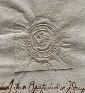 Round imprint of the seal of the town of Polaniec. Royal eagle standing, holding a horn in its