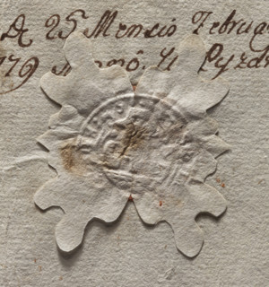 Round seal impression of the town of Pyzdry. Central drawing and inscription illegible. Depicts a