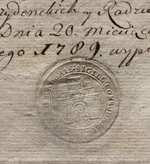 Round seal impression of the city of Radom. City wall with an open gate; in the gate the letter R,