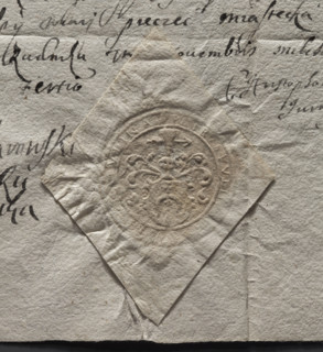 Round imprint of the Rudnik town seal. Illegible coat of arms on the shield. Above the crowned