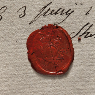 Round imprint of the seal of the town of Stopnica. In a decorative cartouche a key—bit upward.