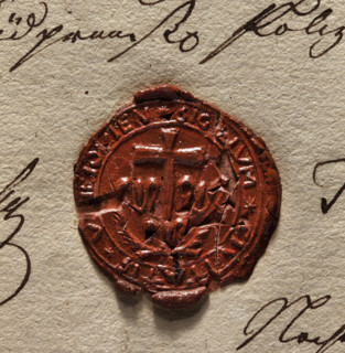 Round wax impression of the seal of the town of Uniejów. A cross standing on a lily, two palm