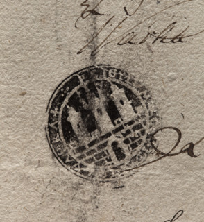 Round ink print of the seal of the town of Warka. City wall with an open gate and battlements.