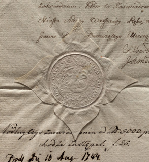 Round impression of the seal of the city of Warsaw. In a Baroque cartouche a mermaid with a fish