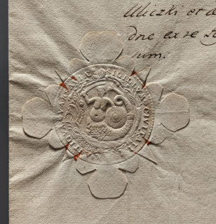 Round impression of the seal of the city of Warsaw. In a baroque cartouche a mermaid with a fish